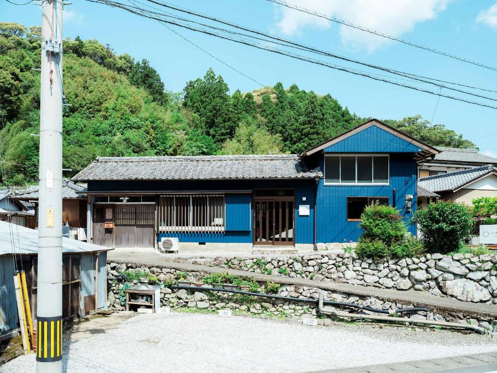 a blue building next to a train station at いなかじかん in Yasuda