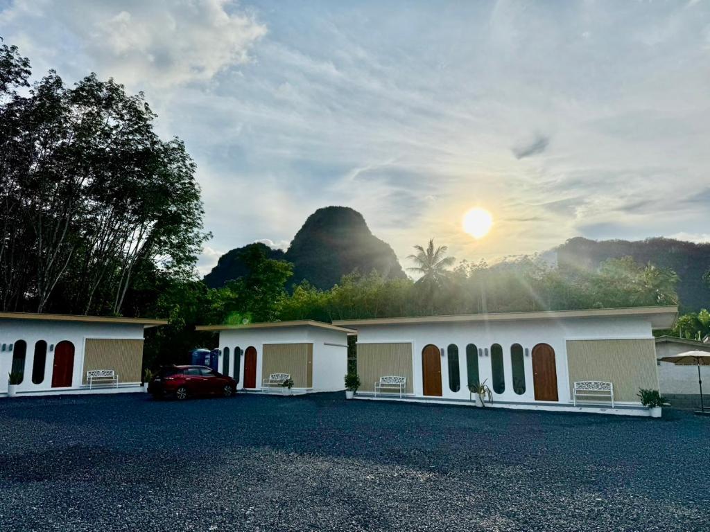 a building with a car parked in a parking lot at Farinda Resort in Phangnga