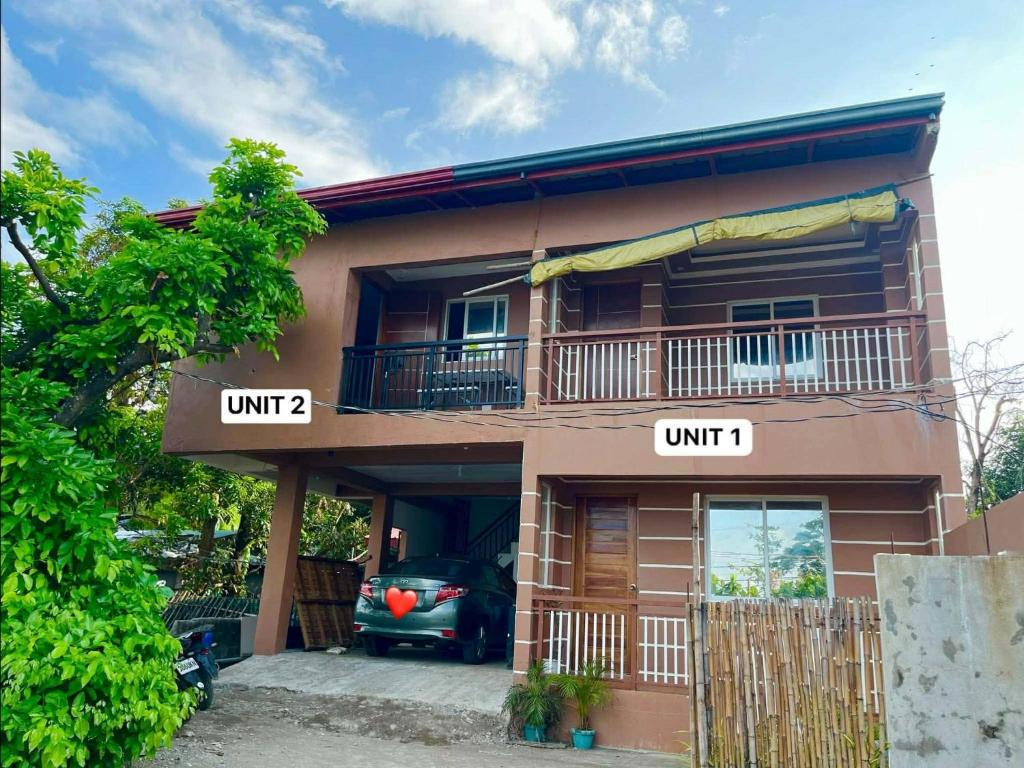a house with a car parked in front of it at Lia Clarke Transient House in Nasugbu