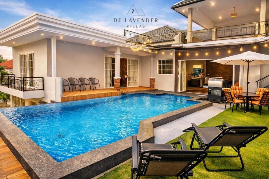 a pool in the backyard of a house at De Lavender Villa 1 in Citaringgul 1
