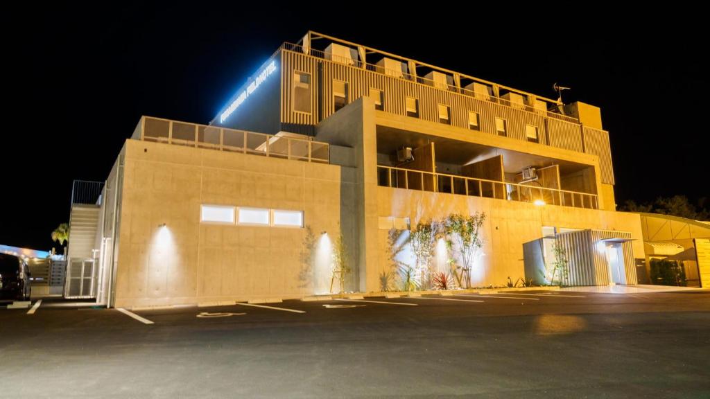 a building with a light on top of it at night at Fukiagehama Field Hotel in Ichikikushikino