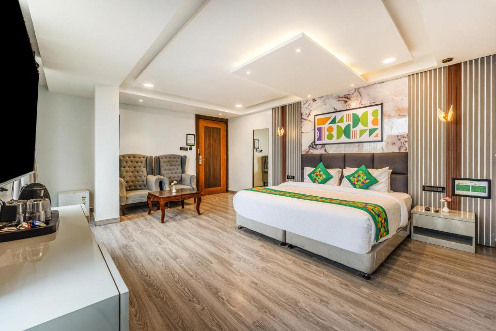 a hotel room with a bed and a tv at Treebo Premium Landmark Prayagraj in Prayagraj