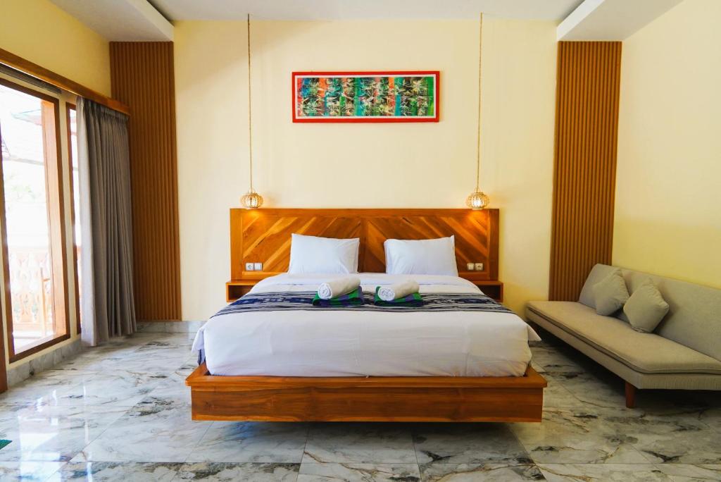 a bedroom with a large bed and a couch at Salili Resort in Gili Islands