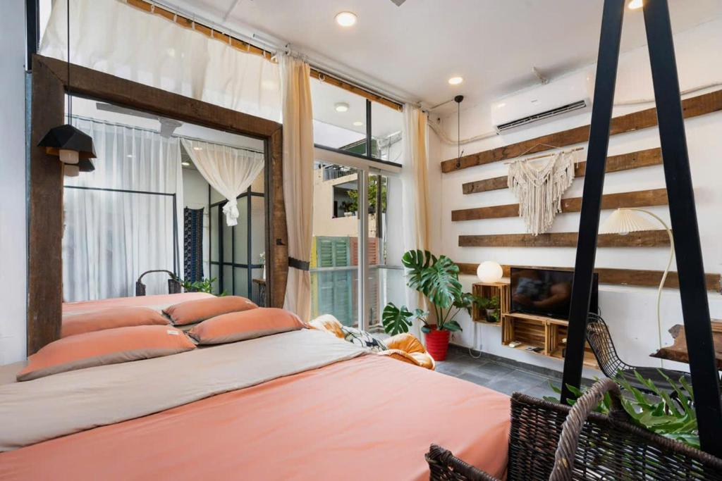 a bedroom with a bed and a large window at StayX Central Suites Q1 in Ho Chi Minh City