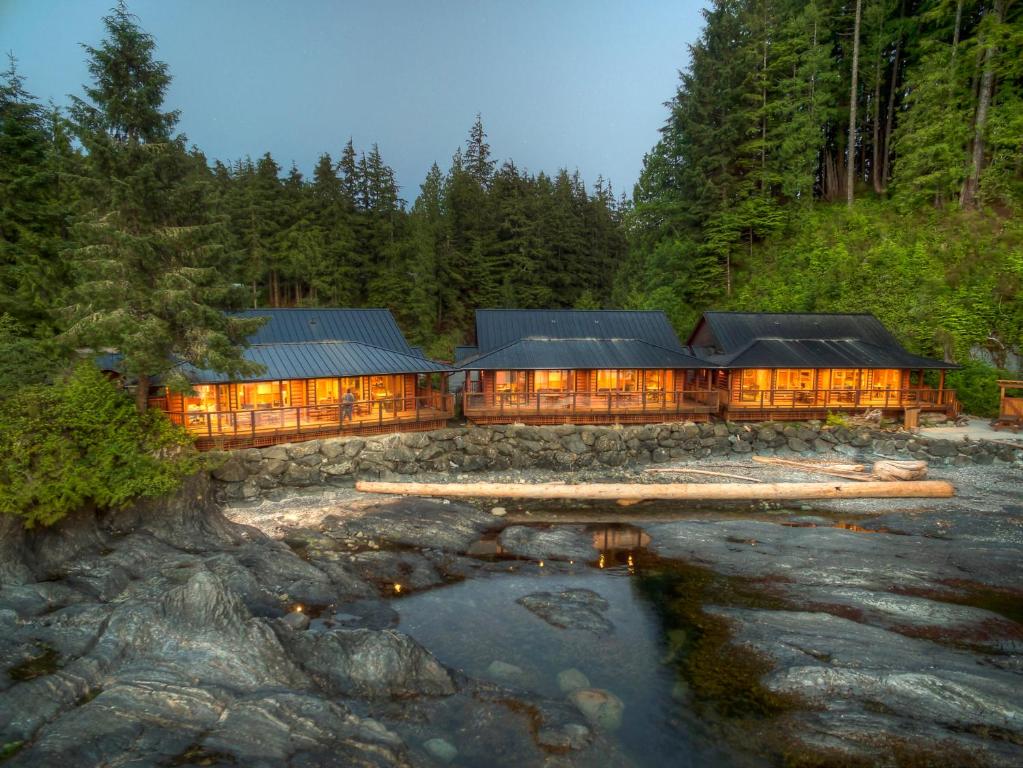 a large house in the middle of a river at Wild Renfrew Seaside Cottages in Port Renfrew