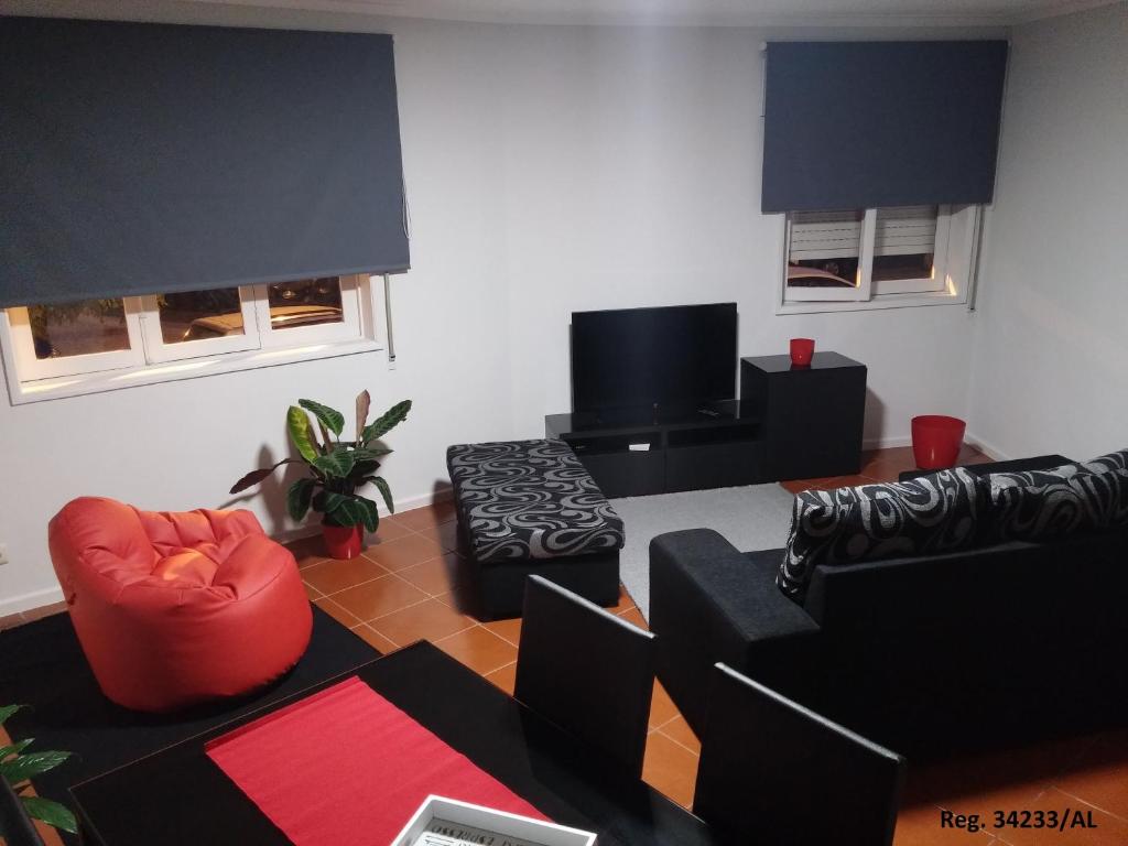 a living room with black and red furniture at Douro & Sea - River Side in Vila Nova de Gaia