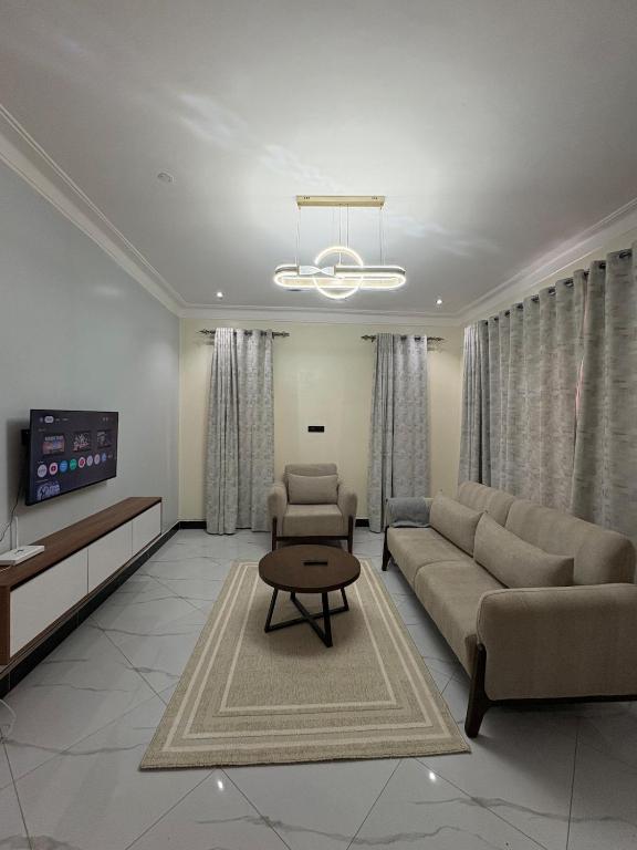 a living room with a couch and a table at Sunset Hideout Kulambiro in Kampala