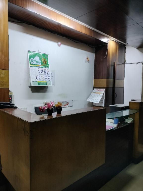 a kitchen with a counter with a calendar on the wall at Sun Classic Residency in Chennai