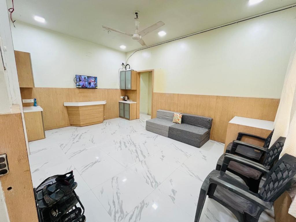 a large living room with a couch and a table at Book the Entire Villa or Choose a Room for a Comfortable Homestay Experience in Solapur