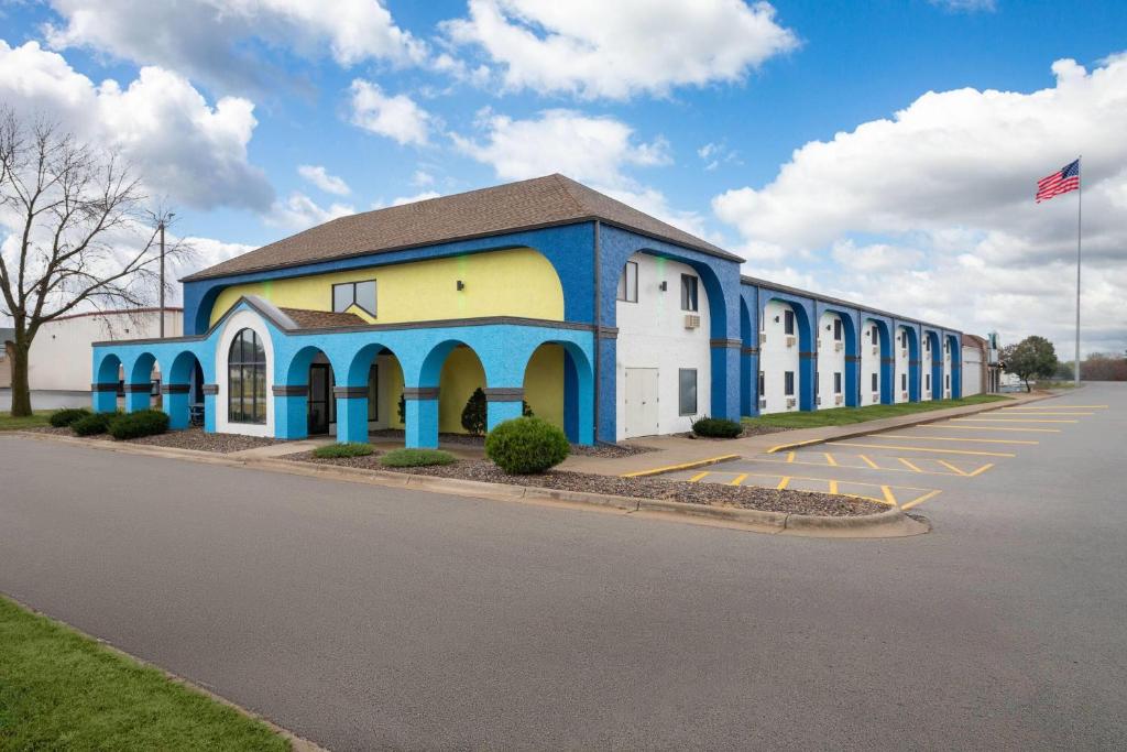 a blue and white building with a parking lot at Days Inn by Wyndham Austin in Austin