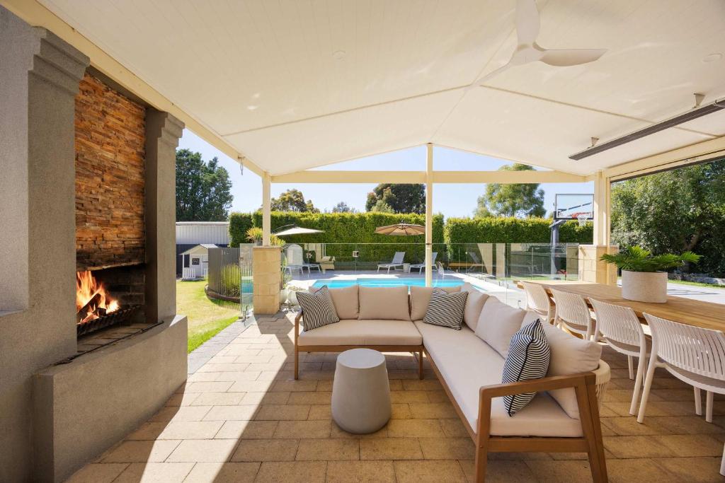 a living room with a couch and a fireplace at Play on Balcombe in Mount Martha
