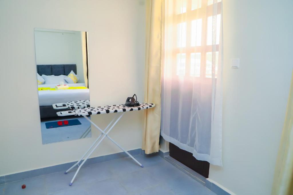 a dressing table in a room with a mirror at NayaLoft in Naivasha