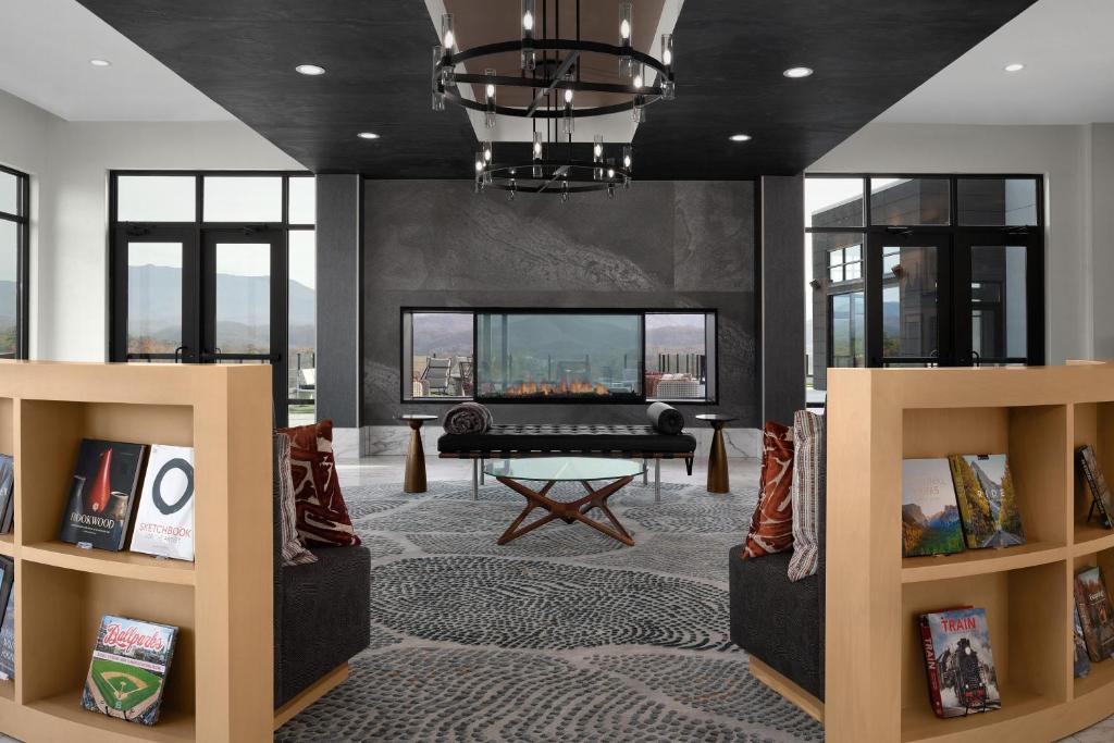a living room with a fireplace and a tv at Tempo By Hilton Pigeon Forge in Pigeon Forge