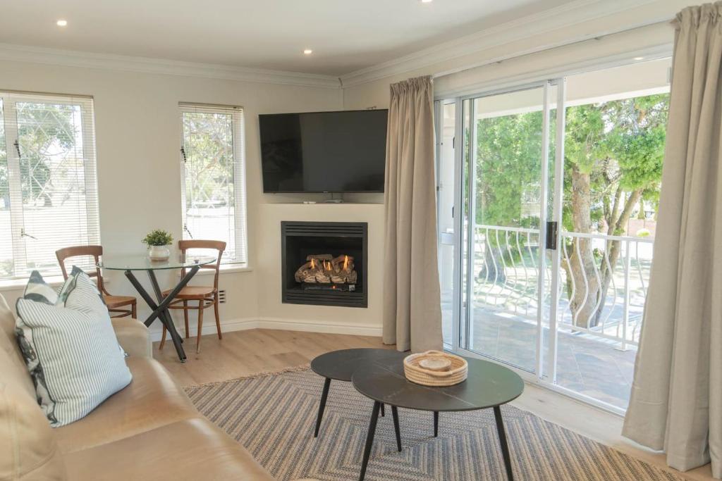 a living room with a couch and a fireplace at Brooklands Sanctuary in Gqeberha