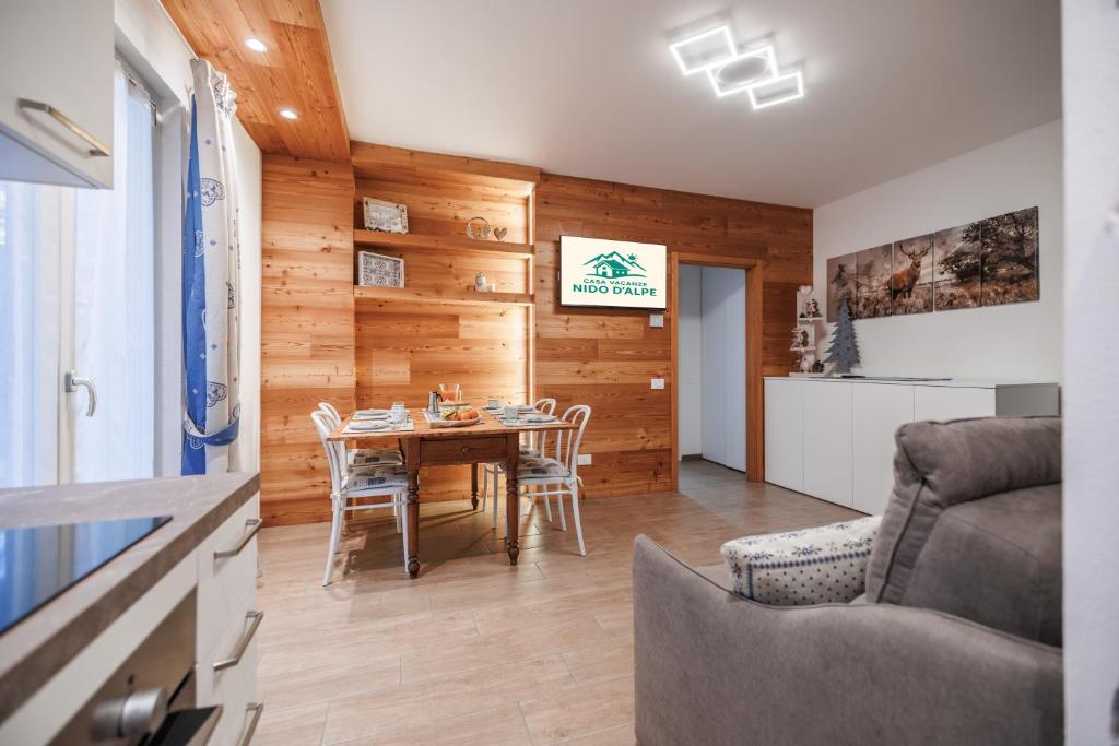 a kitchen and dining room with a table and chairs at CHALET GIOVANNI apricacasevacanze in Aprica