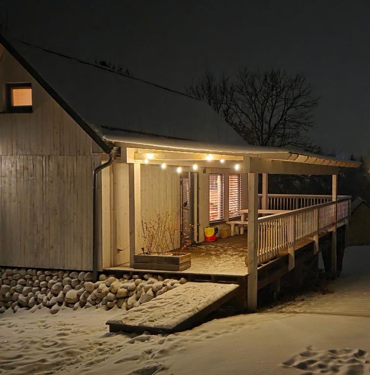 a house with a deck with lights on it at Chatka Katka in Východná