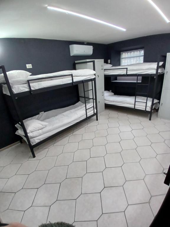 two bunk beds in a room with a tile floor at LIBERTY Hostel in Mykolaiv