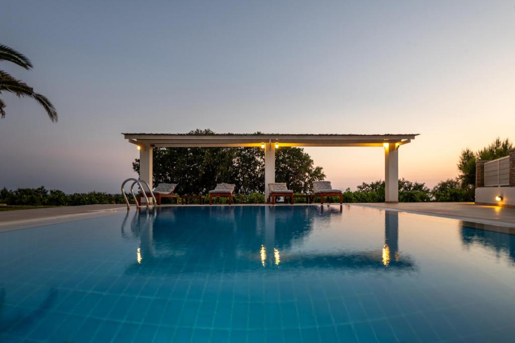 a swimming pool with a gazebo at Villa Vinaria Litoa Waterfront in Minia