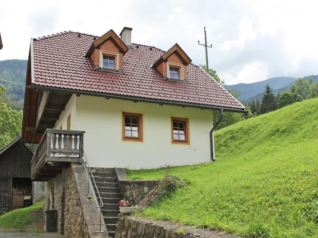 a small house on a green hill with stairs at Peaceful Cottage near Ski Area in Gmünd in Gmünd in Kärnten
