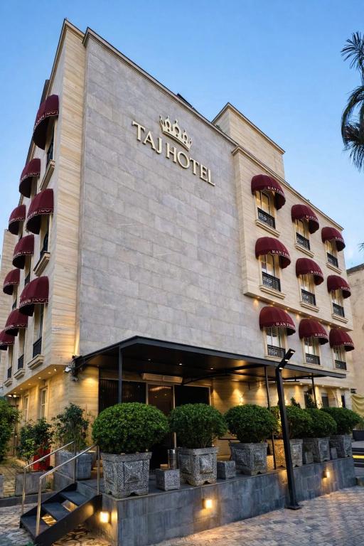 a hotel with a sign on the front of it at Taj Signature Hotel - F7 Markaz Islamabad in Islamabad