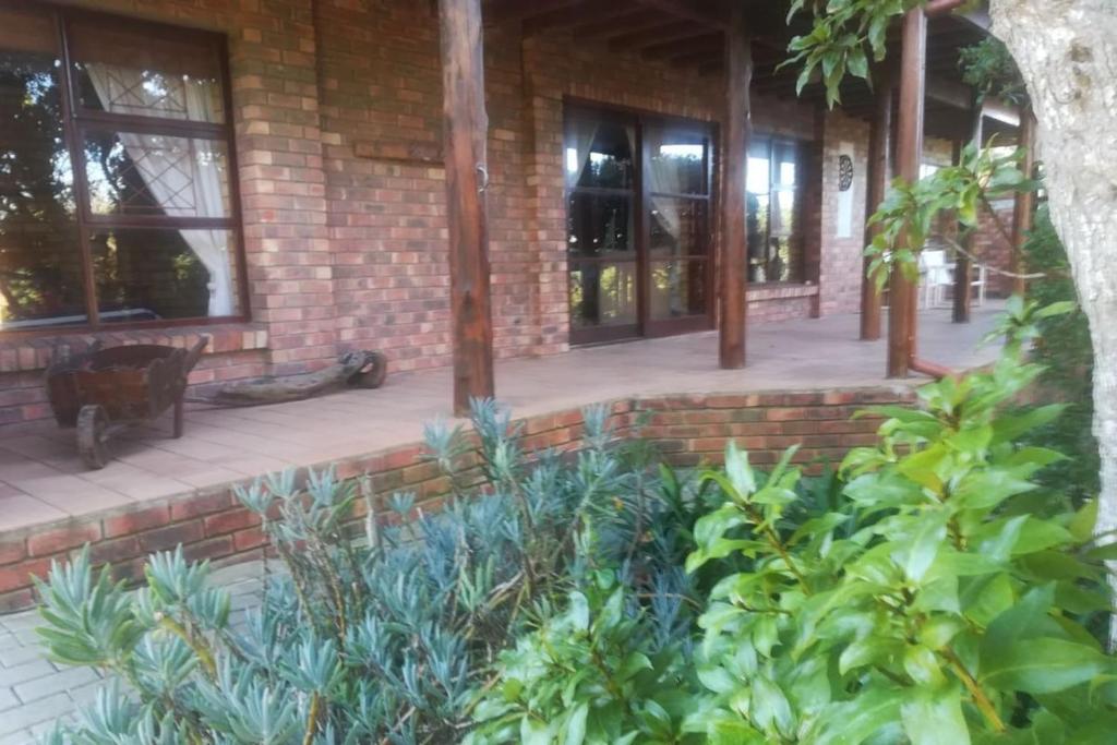 a brick building with windows and plants at Timber and Tide in Cannon Rocks