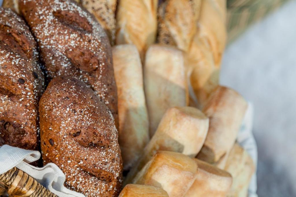a bunch of breads sitting in a basket at Hotel Don Diego in Porto San Paolo