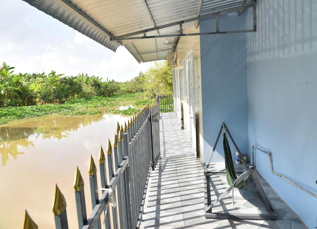 a porch of a house next to a river at Mekongdelta in Can Tho