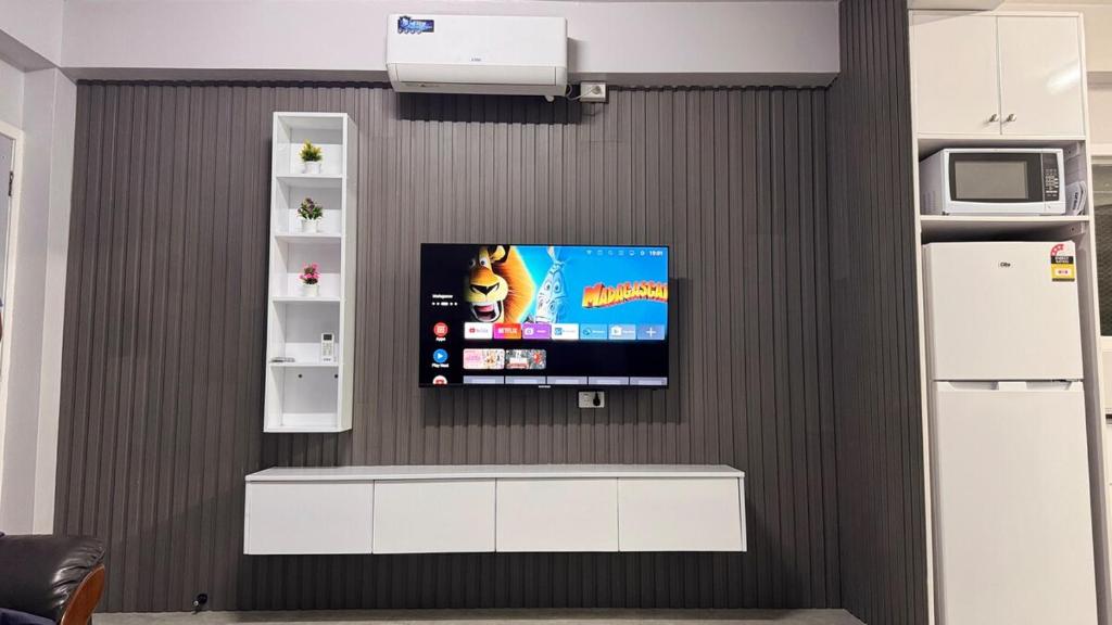 a flat screen tv on a wall in a kitchen at 2 bedroom Flat in Namaka,Nadi in Nadi