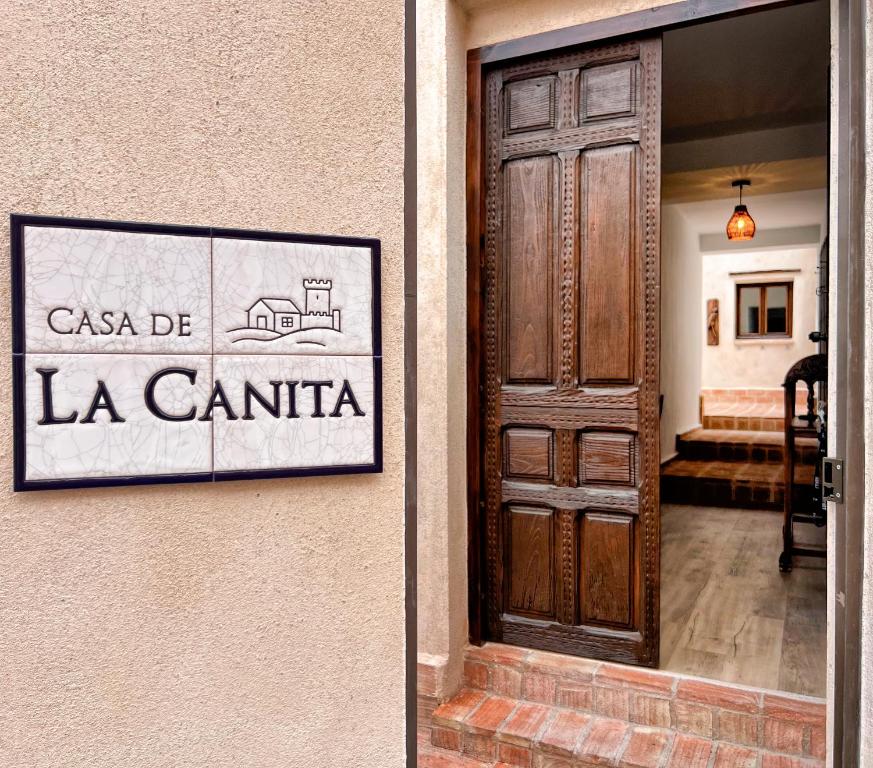 a door to a building with a sign that reads la canaria at Casa de La Canita in Guadamur
