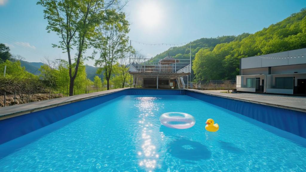 a swimming pool with a rubber duck in the water at GaPyeong Yeoldudal Spapension&Camping in Gapyeong