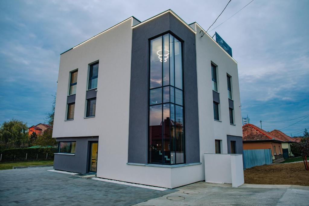 a white building with a large window at The Butterfly in Sângeorgiu de Mureș