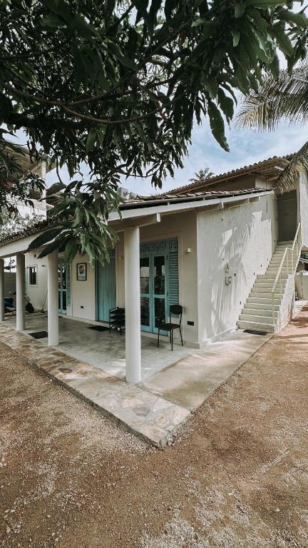 a house with a porch and a stair case at Testudo Madiha in Matara