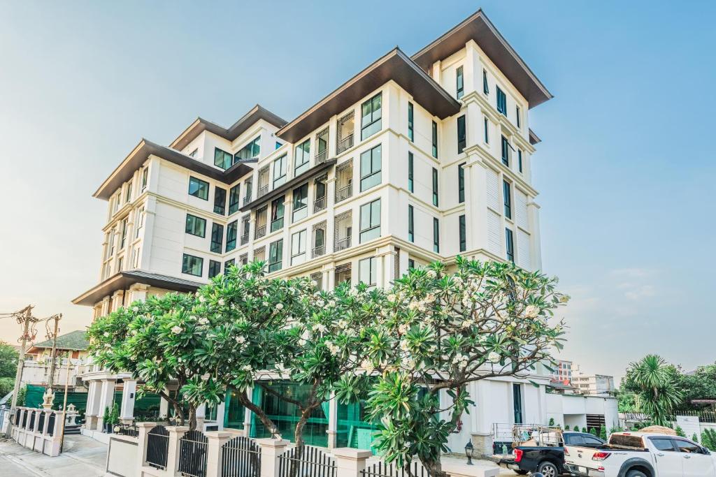a large white building with trees in front of it at ZAYN Bangna Hotel in Bangna