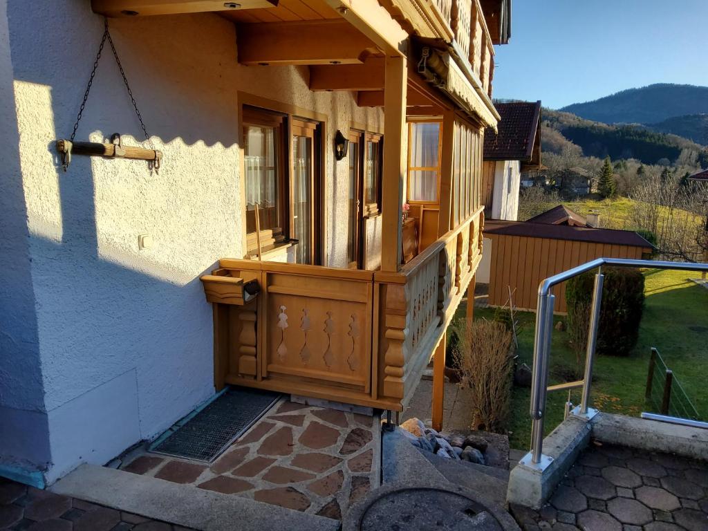 a house with a wooden door and a porch at Ferienwohnung Renate in Siegsdorf