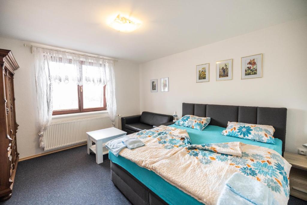 a bedroom with a bed and a couch at Apartmán Absolon Blansko in Blansko