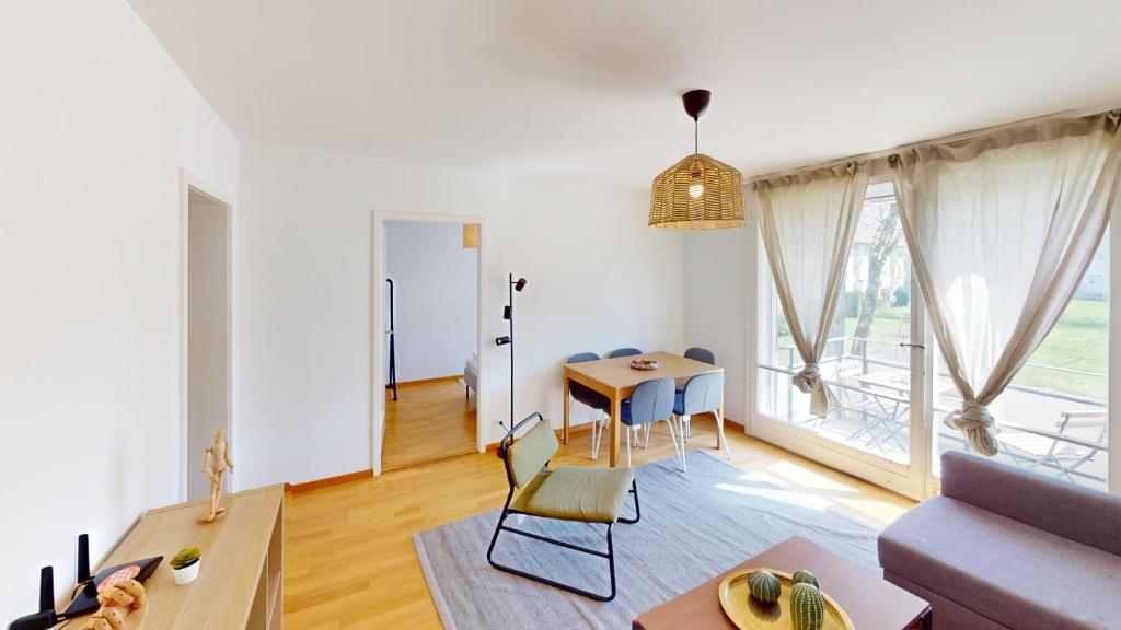 a living room with a table and a couch at Functional Stay with Balcony in Zurich