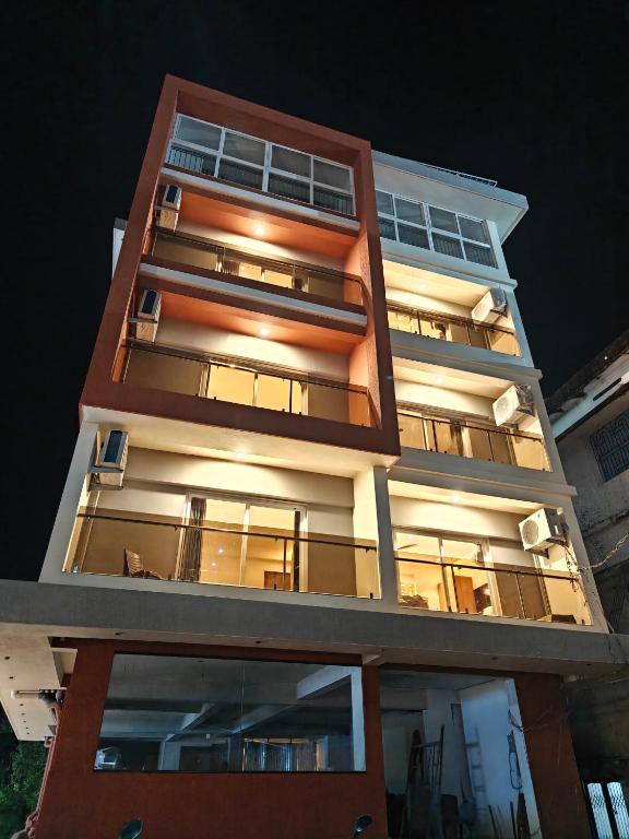 a tall building with its lights on at night at Neelram Hospitality in Mangalore