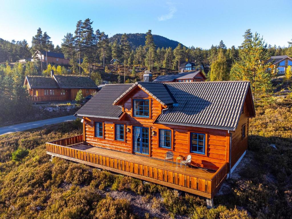 a wooden house with a solar roof on a hill at Marits Hytte 6p in Vradal