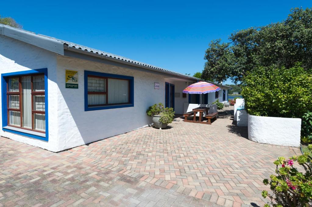 a white house with a brick driveway at Estuary Cottage in Sedgefield