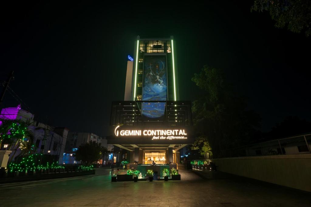 a building with a lit up sign at night at Gemini Continental, Hazratganj in Lucknow