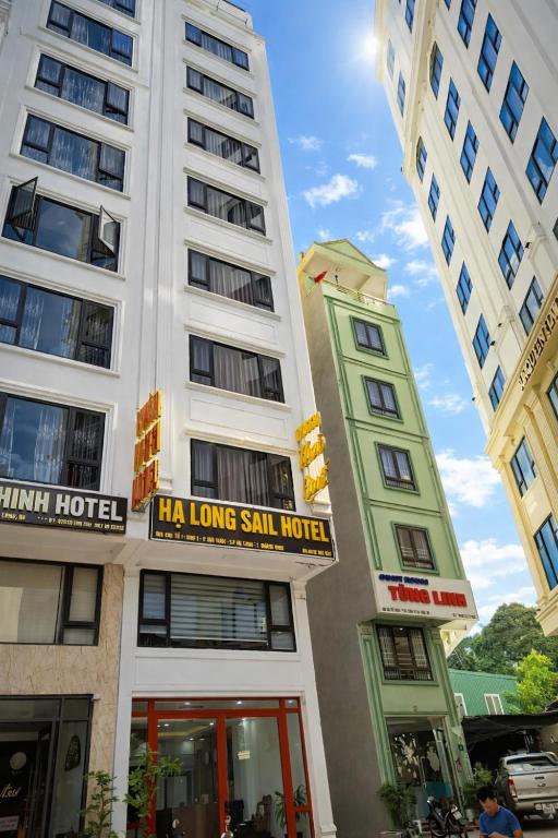 a white building with a sign that reads la long ski hotel at Sail Hotel Hạ Long in Ha Long