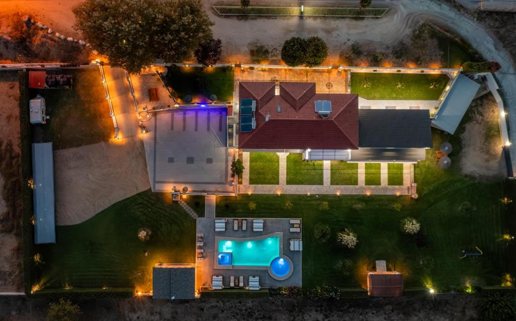 an aerial view of a house with a swimming pool at A Ponte Studios & Apartments in Sykia Chalkidikis