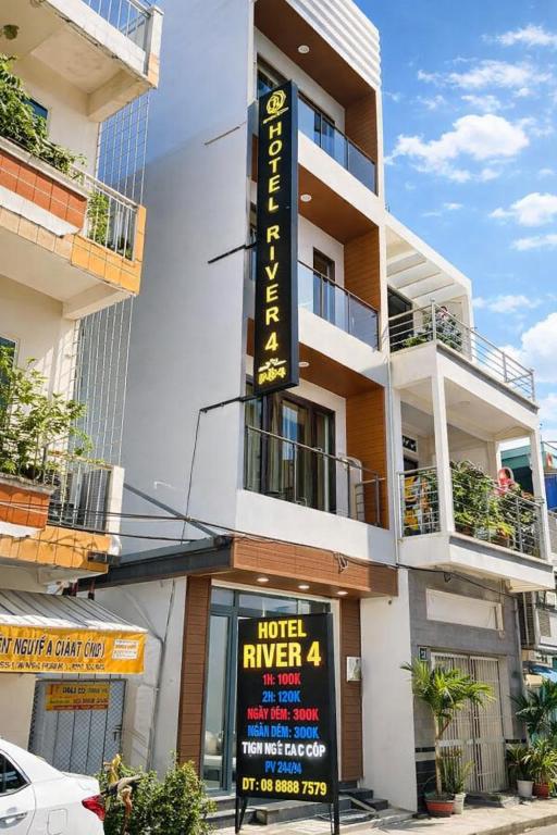 a building with a hotelryan sign in front of it at River Hotel 4 Long Xuyên in Long Xuyên
