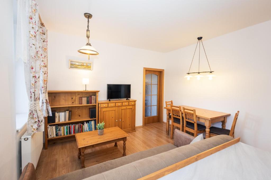 a living room with a couch and a table at Apartmán Černý Důl in Černý Dŭl