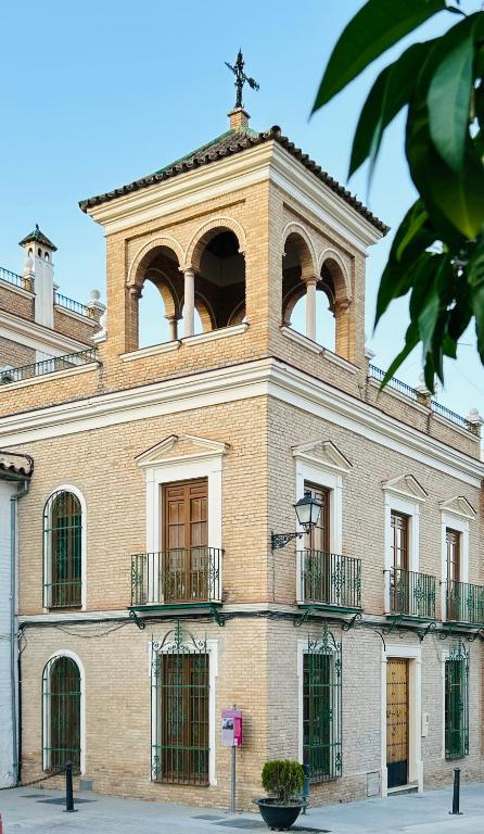 a building with a cross on the top of it at Casona de Santa Ana in Cuevas Bajas