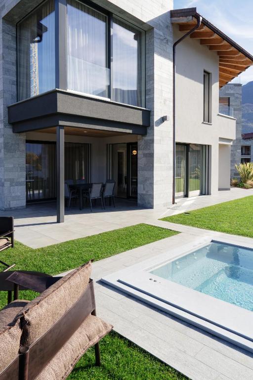 a house with a swimming pool in the yard at Lago Dorato Townhouse Sabrina by the Como lake in Colico