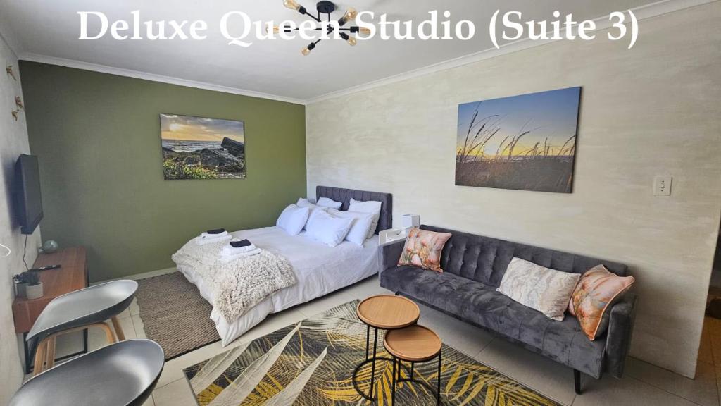a living room with a bed and a couch at Deep South Suites in Cape Town