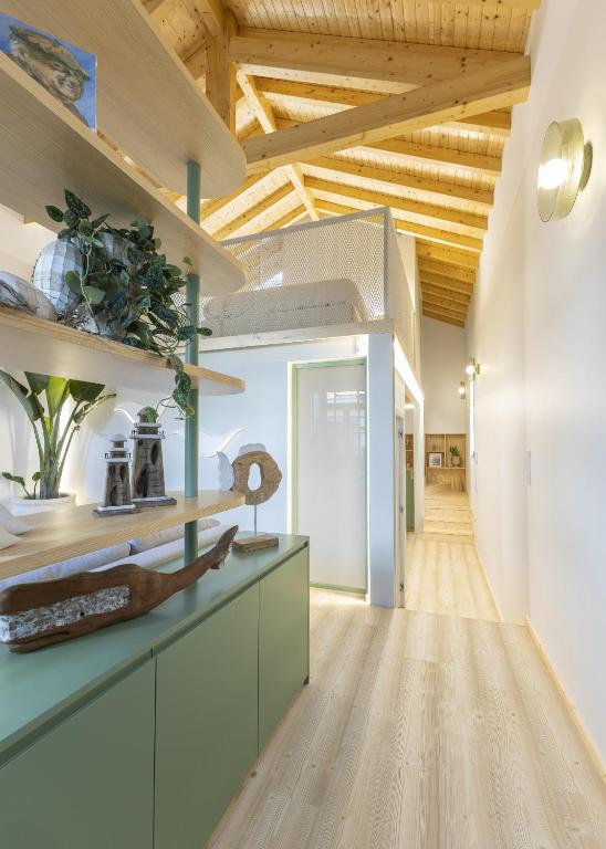 a kitchen with green cabinets and a wooden ceiling at Lobo do Mar in Viana do Castelo