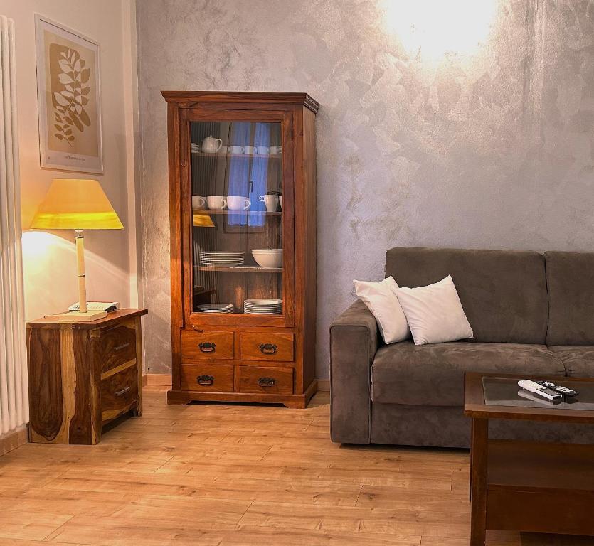 a living room with a couch and a cabinet at Colombo Central Apartment in Garda