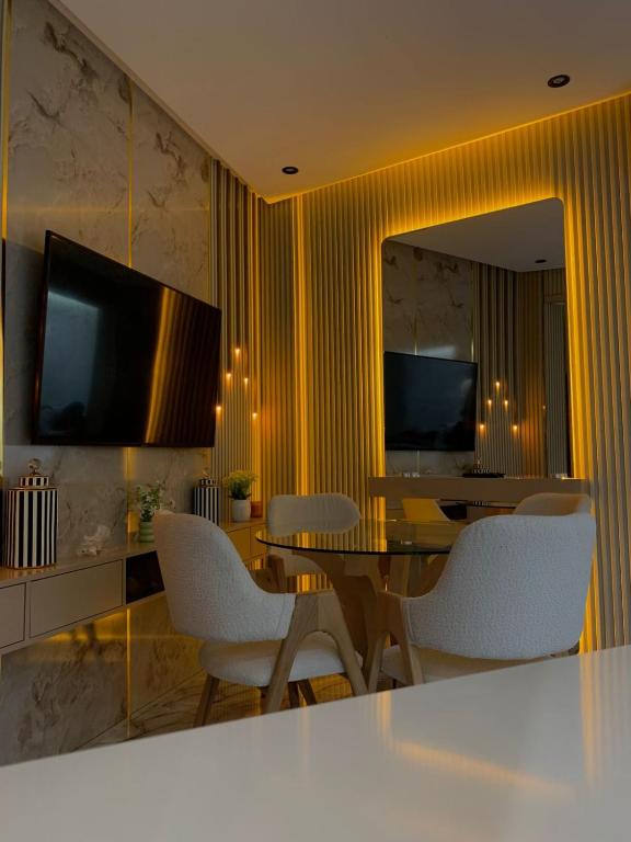 a dining room with a table and white chairs at Casa españa LUXURY in Tangier